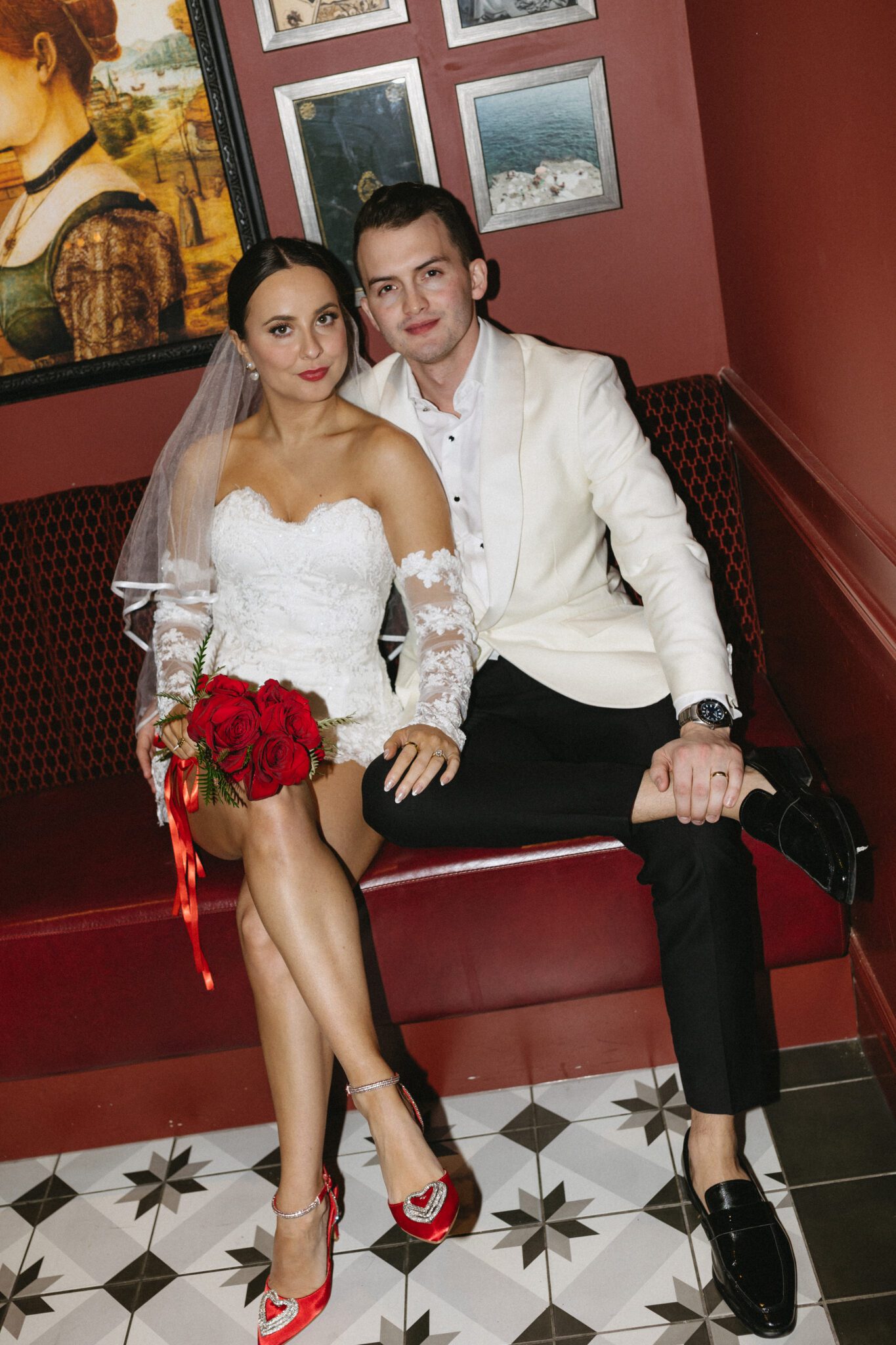 This retro meets modern wedding inspiration in Calgary, showcases modern sophistication, vintage charm, retro details, and a vibrant red colour palette. #brideandgroomattire #lacebridalgown #redrosebouquet #modernweddinginspiration #restaurantreception