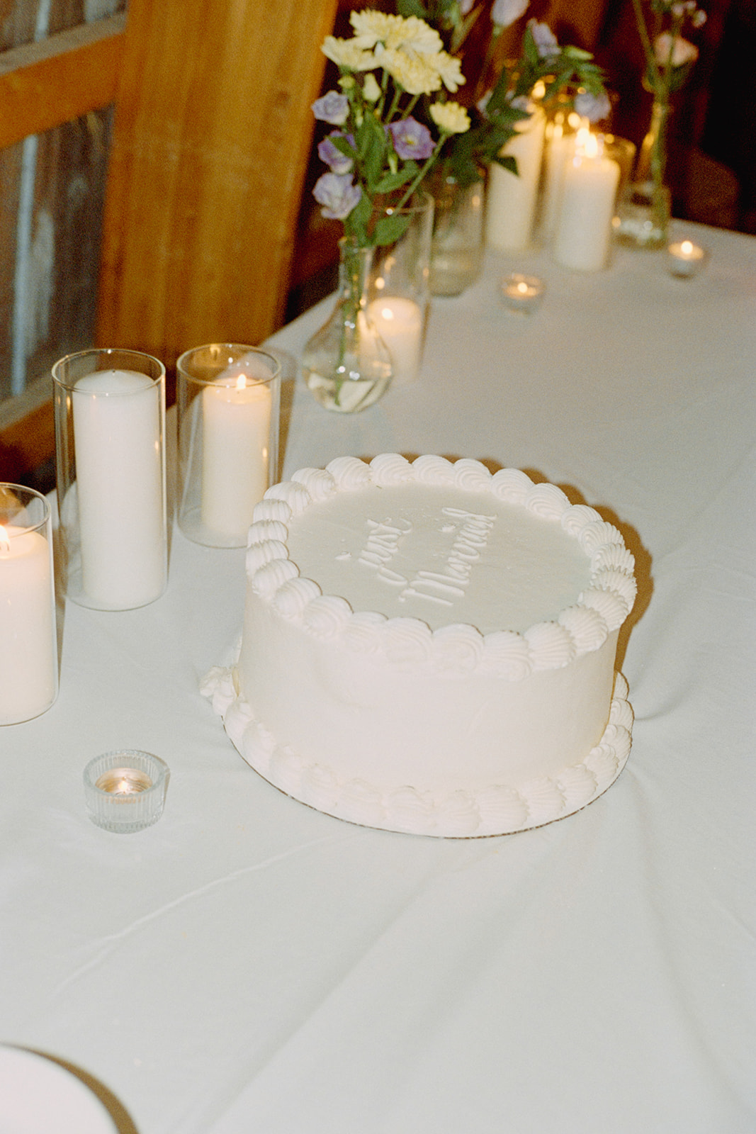Vintage buttercream wedding cake with "just married" written in icing on top