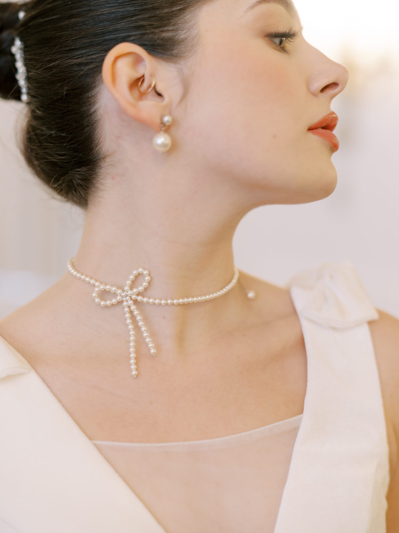 Pearl bow necklace and pearl earrings by Joanna Bisley Designs.