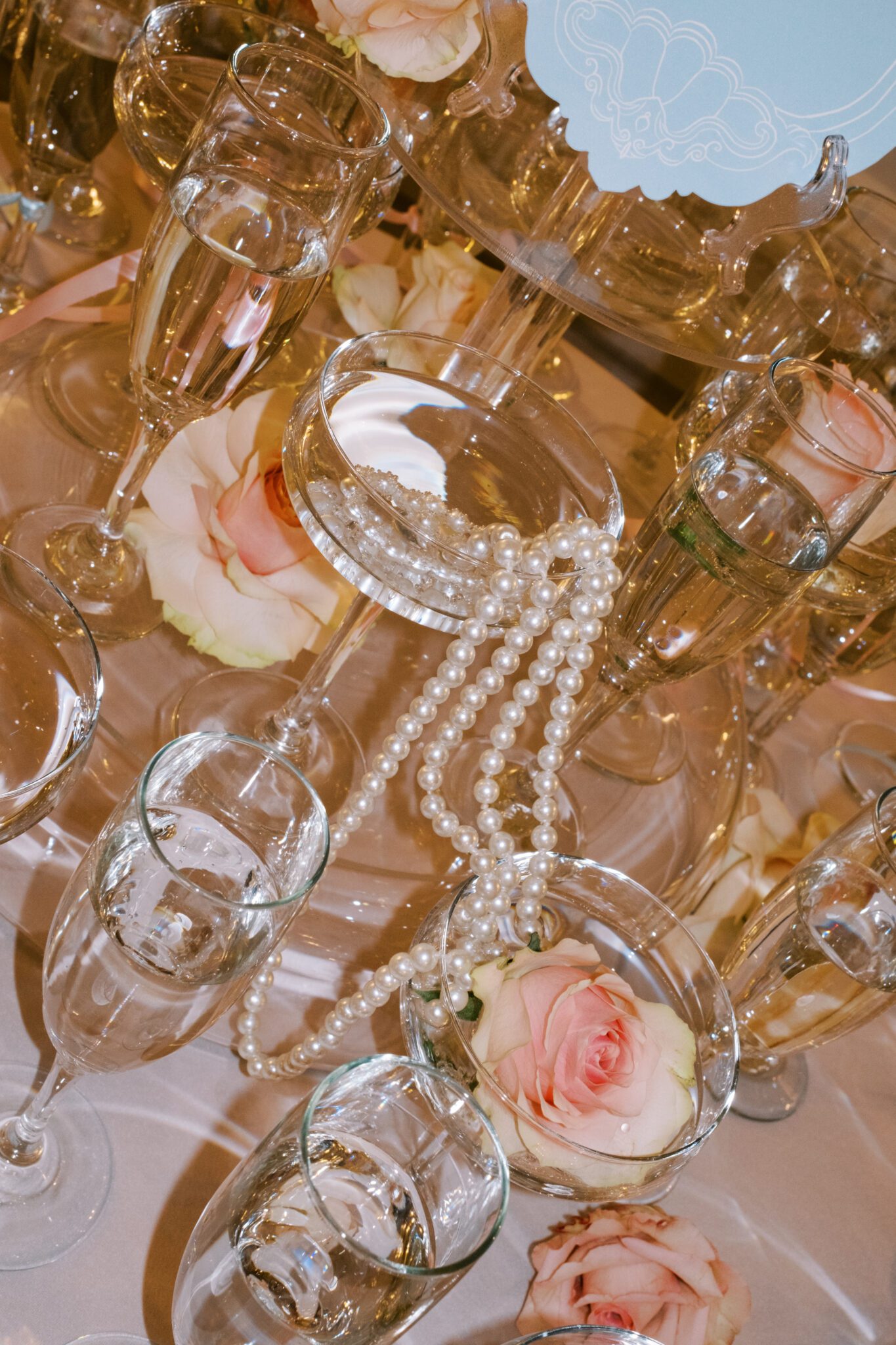 Champagne Tower with pearls and blush roses, flash photography. Whimsical ballet blush pink wedding inspiration at Fairmont Palliser Hotel. 