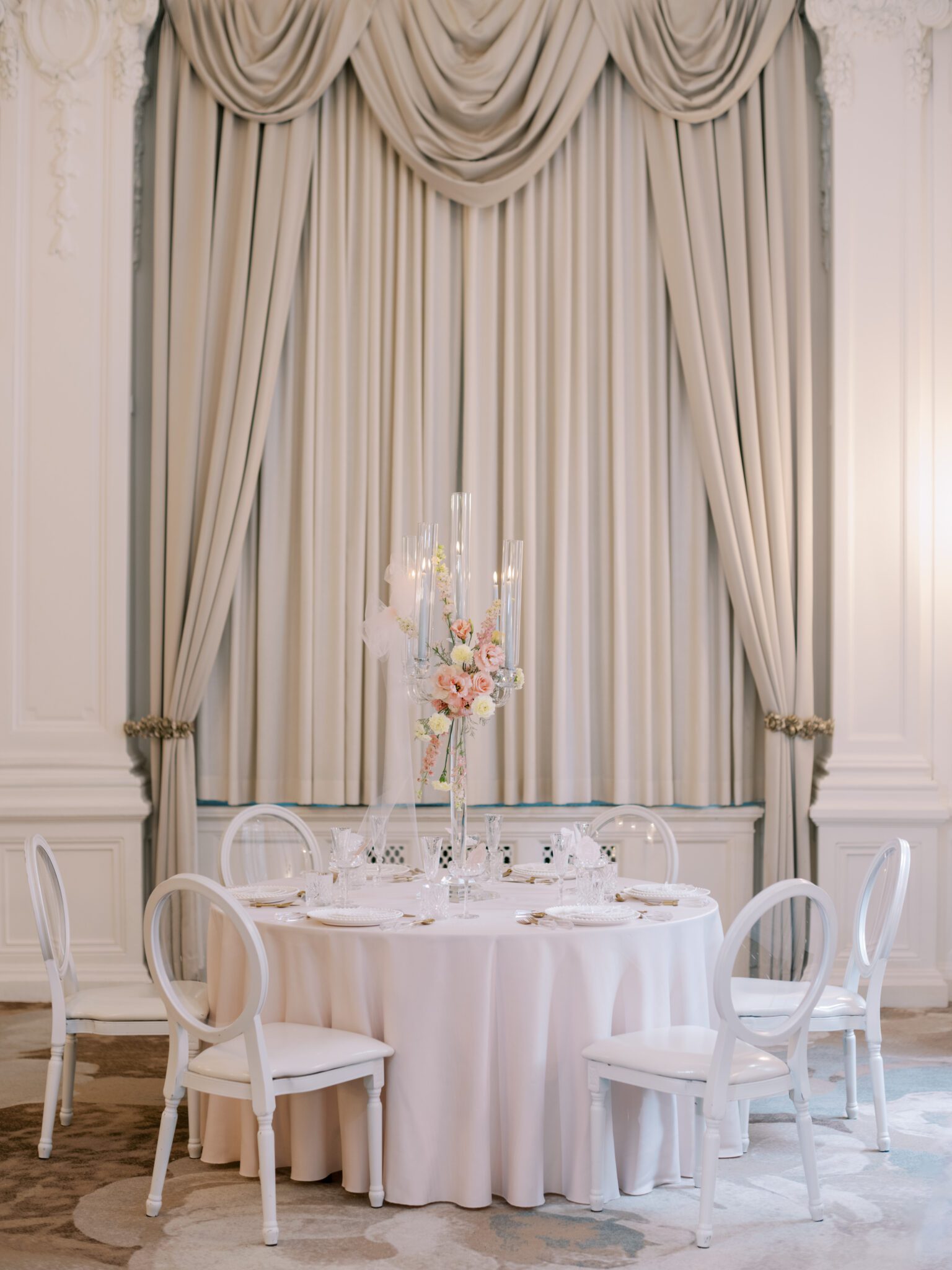 Round blush pink wedding table with crystal candelabra and pale blue candles. Whimsical ballet blush pink wedding inspiration at Fairmont Palliser Hotel. 