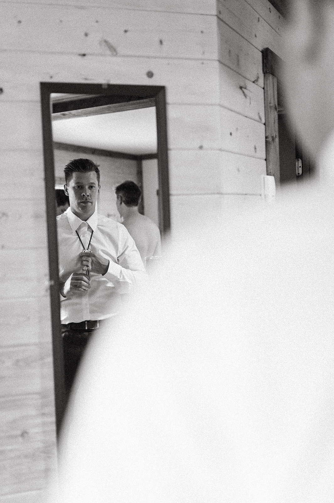 Groom getting ready at Hillside Lodge & Chalets in Golden BC