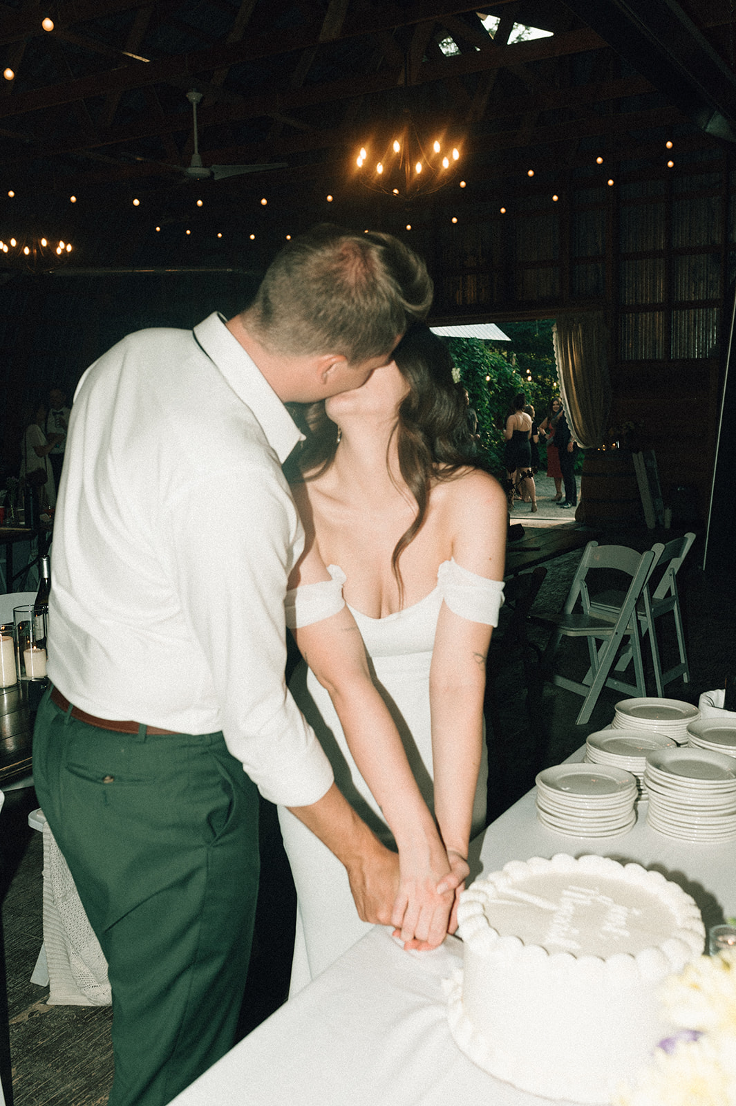 Rustic Summer wedding in Kootenay BC, vintage style barn wedding, bride and groom cake cutting, flash photography