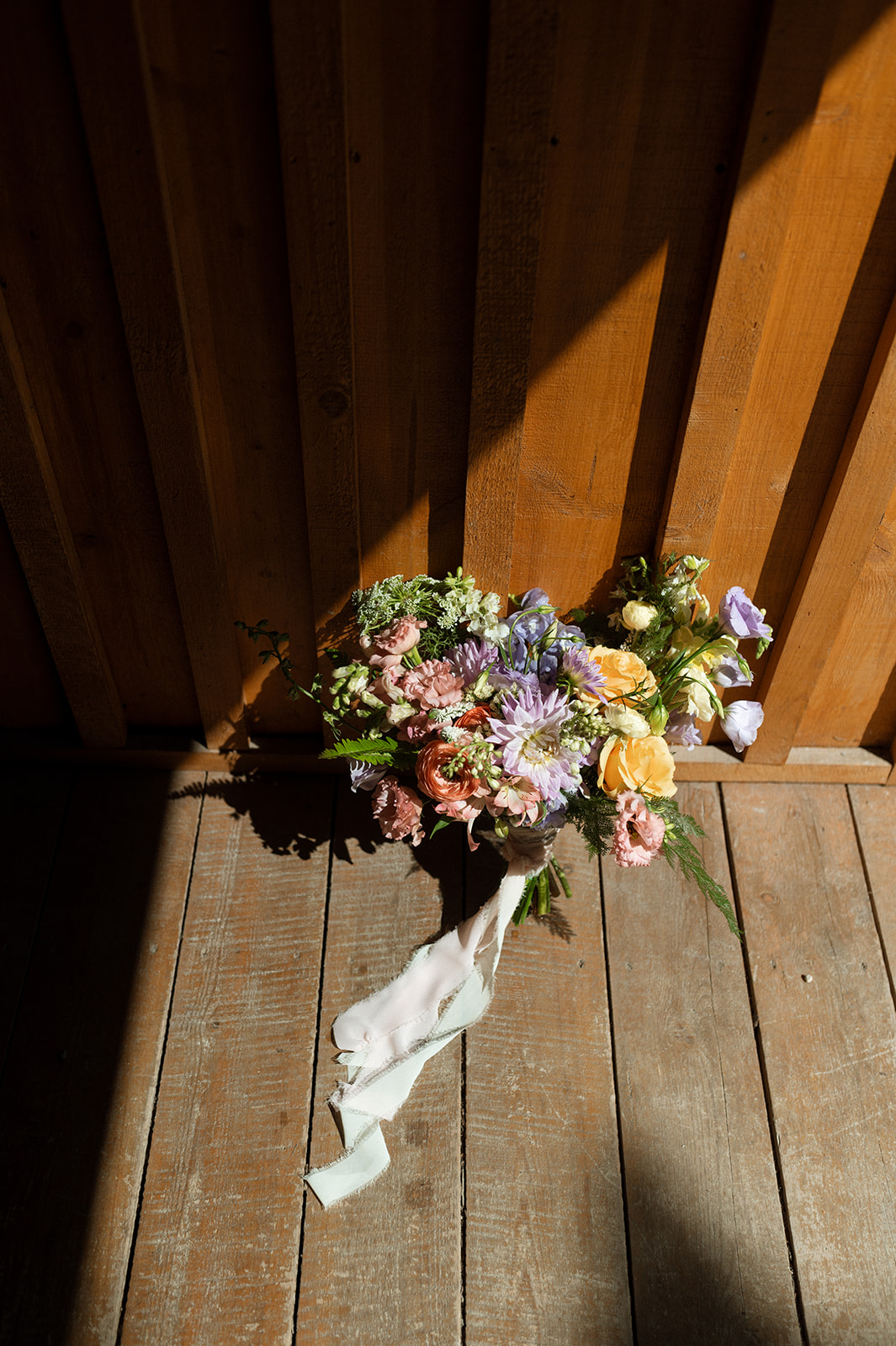 Colourful summer bridal bouquet with vibrant colours and wildflowers.